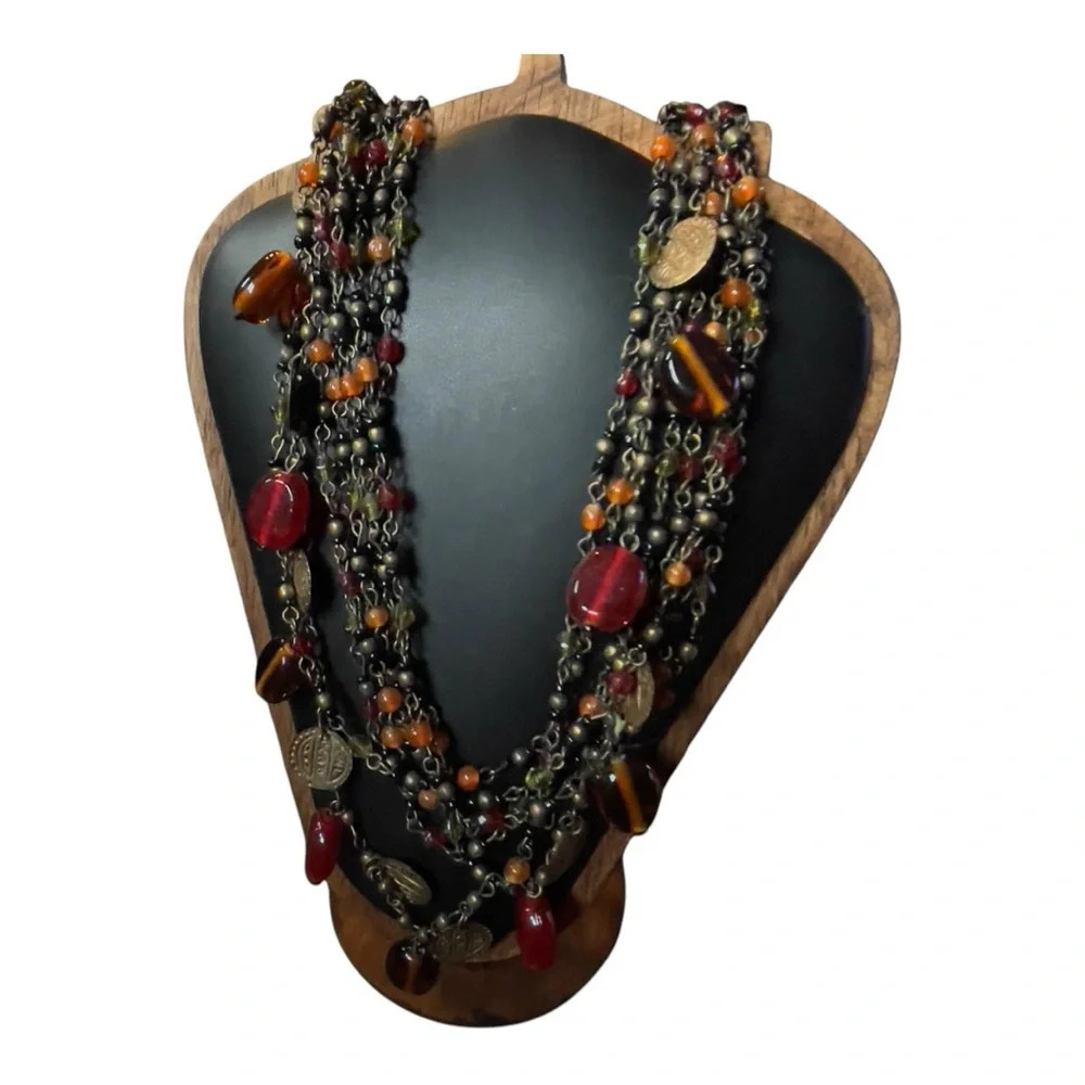 Eight layered glass bead and brass necklaces. Orange red black gold